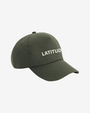 A Cap - Green by 2025 in olive green, featuring LATITUD embroidered in white uppercase letters on the front, shown on a plain white background.