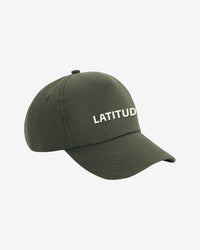 A Cap - Green by 2025 in olive green, featuring LATITUD embroidered in white uppercase letters on the front, shown on a plain white background.