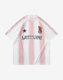 The 2025 Football Shirt is a short-sleeved tee with vertical pink and white stripes, a black star, crest with B, and LATITUDE printed on the chest.
