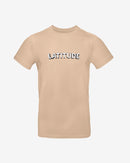 The 2025 Latitude Event T Shirt - Sand features the word LATITUDE in bold, white, uppercase letters outlined in black across the chest.