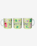 Set of three Latitude Green Mugs by 2025, each with pastel flower and music note patterns. Together, they spell “LATITUDE” in bold letters and feature pink and purple cartoon sheep dancing on either side.