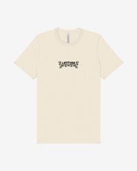 The Latitude 2025 Pink Sheep Natural T-Shirt from the Latitude Festival Store is a cream unisex tee made from soft Airlume cotton, featuring LATITUDE in bold black letters with decorative flourishes centered on the chest.
