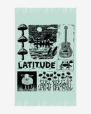 The 2025 Knitted Blanket features fringe and illustrations of mushrooms, a sunset lake with canoe, guitar, frog, sheep, wildflowers, and “LATITUDE” in bold at the center.