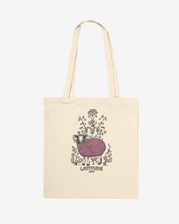 Beige tote bag with a printed design of a sheep and flowers on a white background