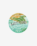 The Latitude Car Sticker by 2025 features a circular graphic with "LATITUDE" in bold over a colorful background, surrounded by the words music, comedy, family, poetry, wellness, literature, theatre, and dance in a ring.