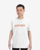 Child wearing a white t-shirt with 'Latitude' printed on it against a white background