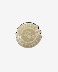 Round button badge with 'Latitude Festival' text on a white background
