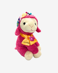 Plush toy with pink outfit and colorful accessories on a white background