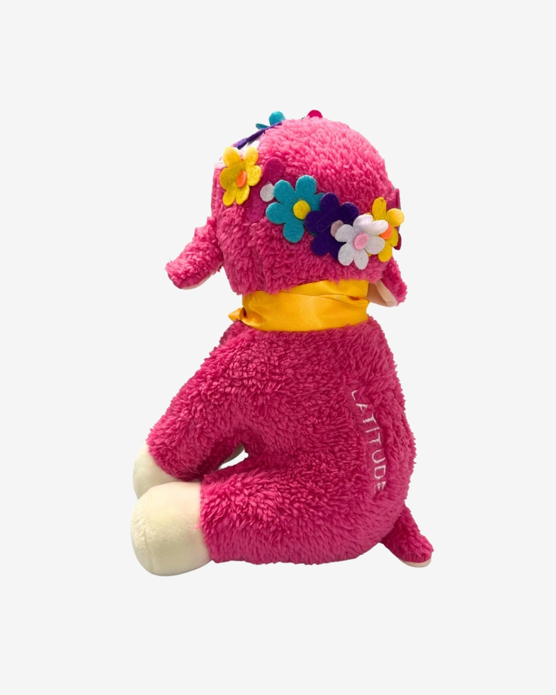 Pink plush toy with floral headband on a white background