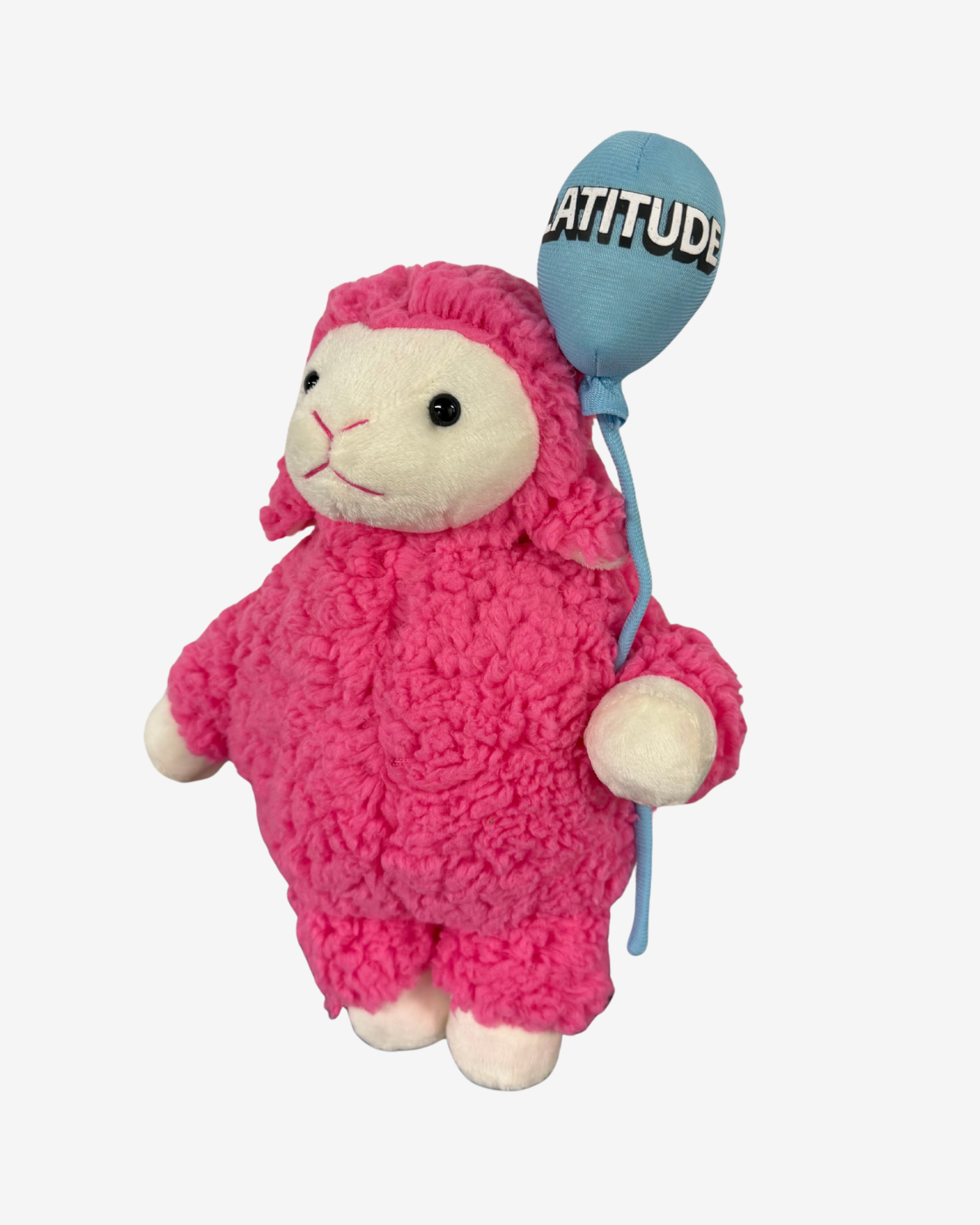 The Latitude Festival 2026 Latitude Plush With Balloon features a plush toy sheep with bright pink fur, holding a blue festival balloon emblazoned with “ATTITUDE” against a plain white background—a cuddly keepsake celebrating the joy of every Latitude Festival.